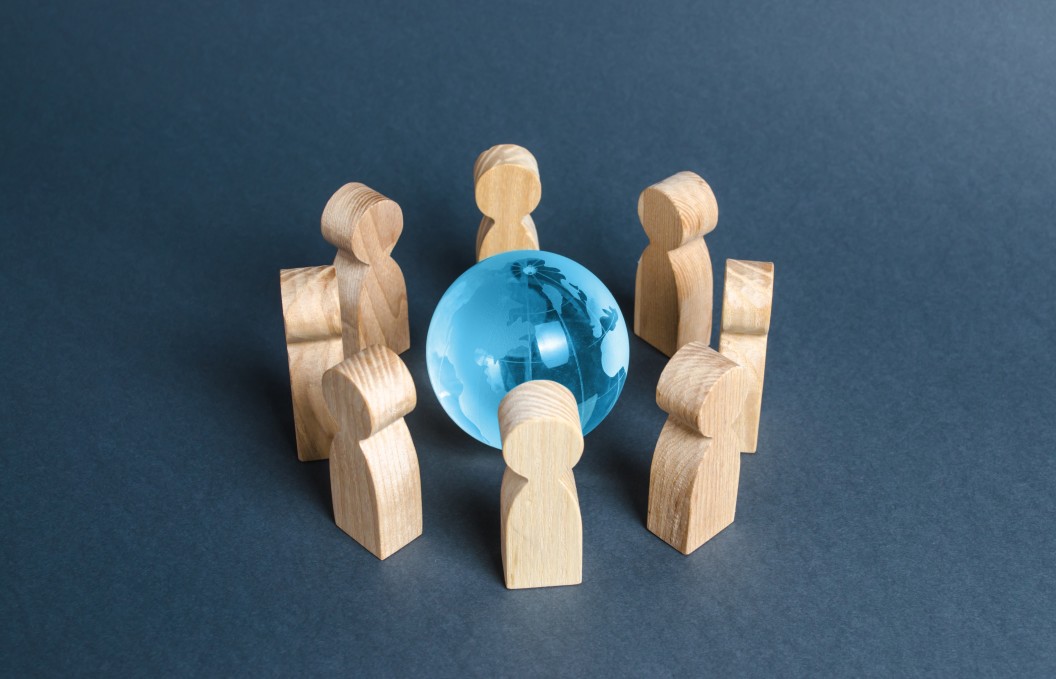 Wooden people surrounding blue globe showing what is bpo and its global effect