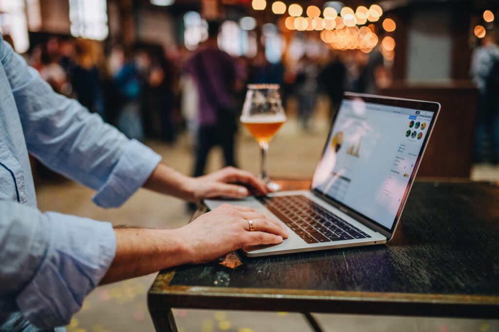 young adult using laptop and mobile phone ecommerce