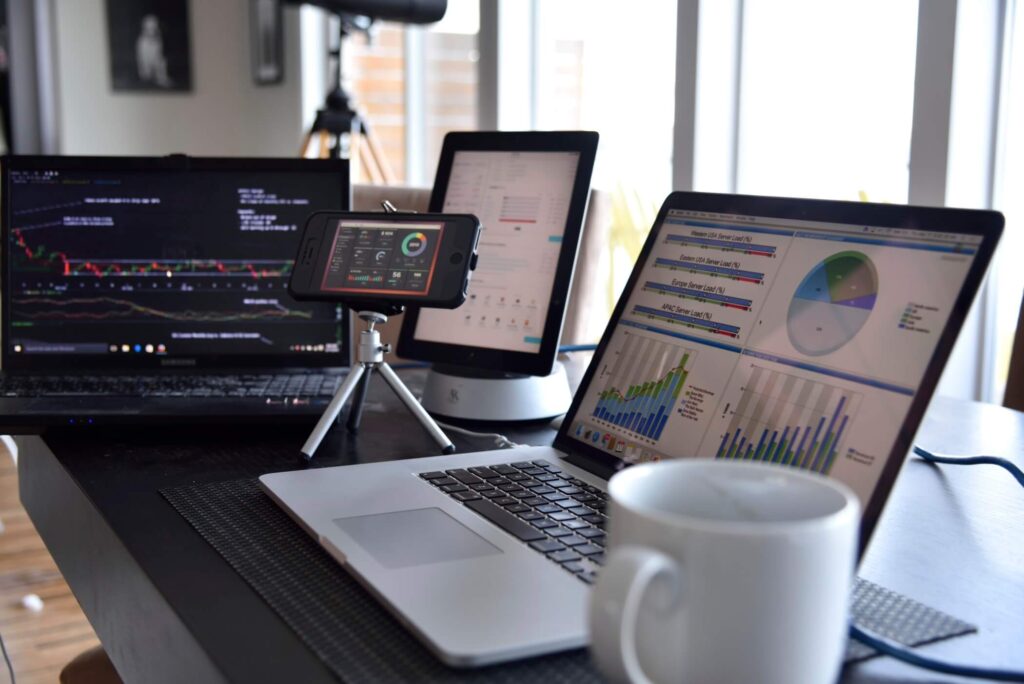 laptop computers and smartphones showing data charts and graphs of site performance