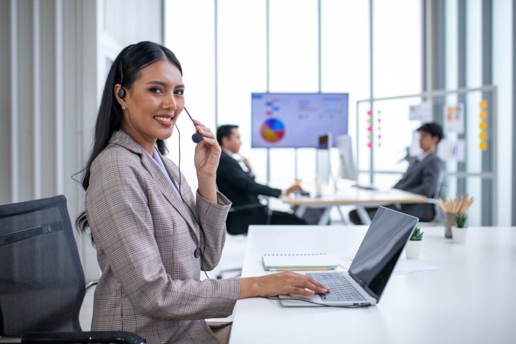 Woman working in outsourcing industry smiling
