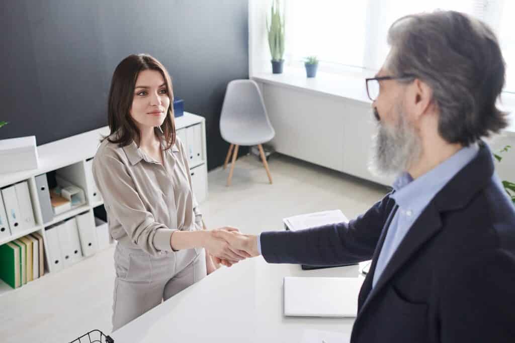 woman shaking hands with professional