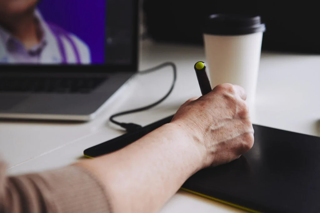 graphic designer working on a design project in tablet and computer 1024x683 1