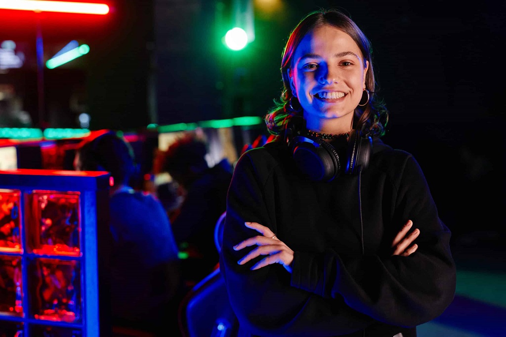 a female game developer smiling and arms crossed