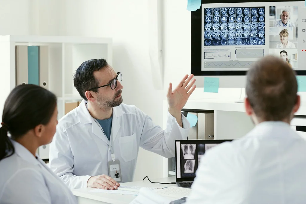 a group of doctors reviewing x rays