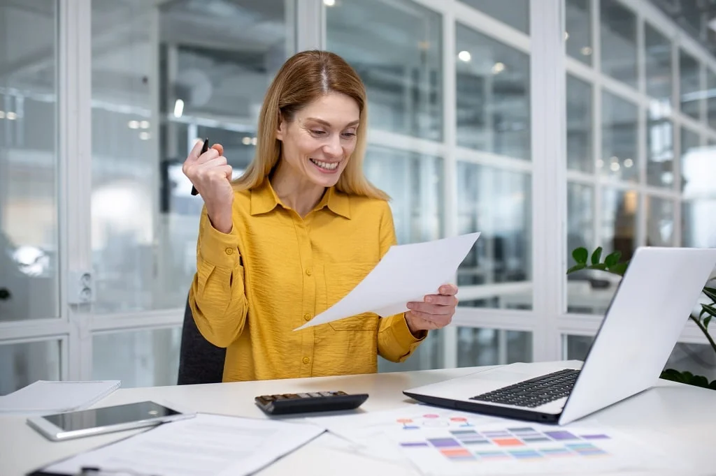 a happy businesswomen satisfied with financial results and income