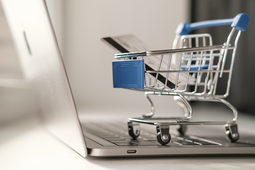 a miniature shopping trolley on a keyboard, symbolizing the concept of ecommerce marketing