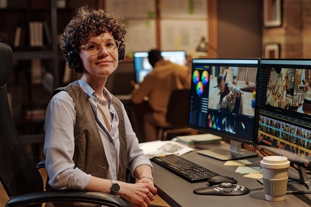 a professional video editor in an office working on her video editing tasks