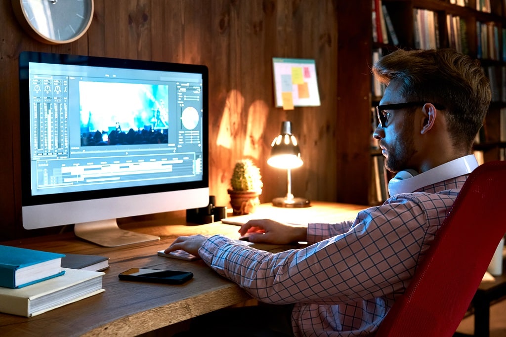 a professional video editor using an advanced computer to create visual content