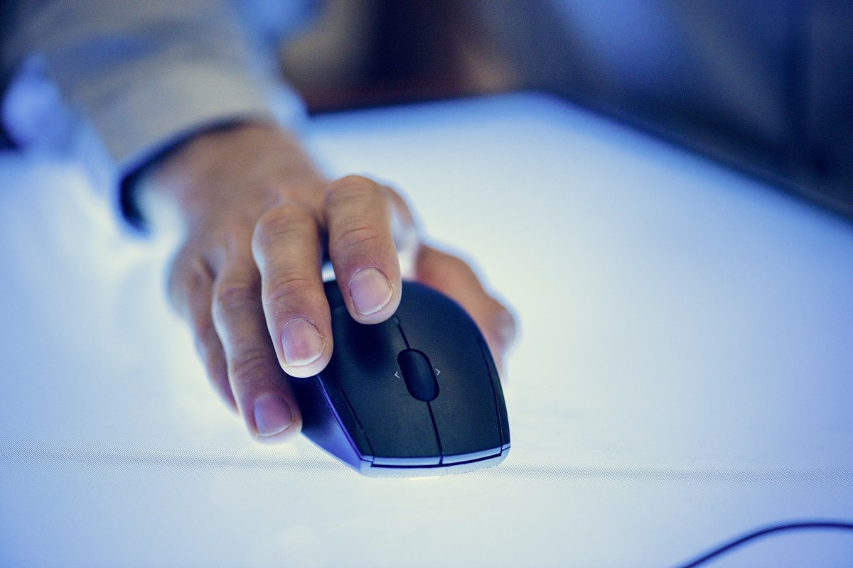 a close-up of a sleek black computer mouse on a smooth surface