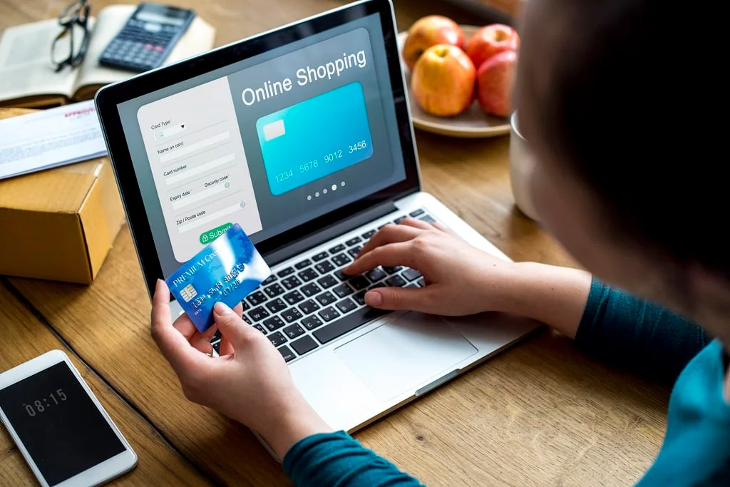 person making an online purchase with a laptop and credit card