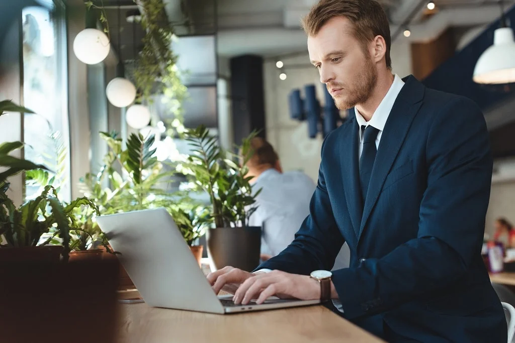 a business executive researching what is telemarketing on his laptop