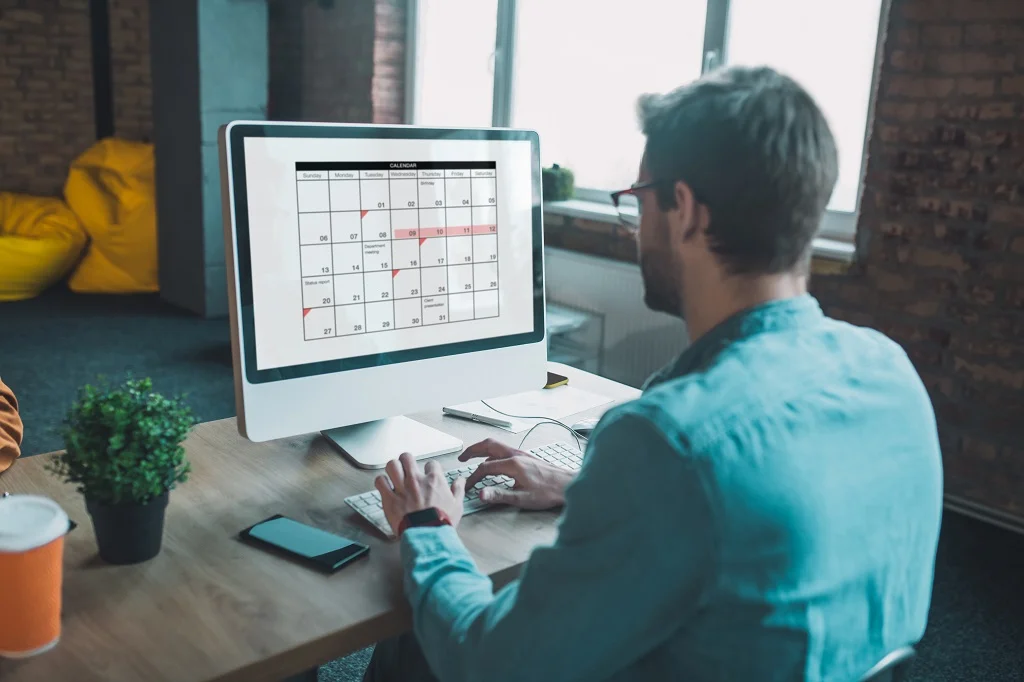 employee planning schedules on a calendar for efficient organization