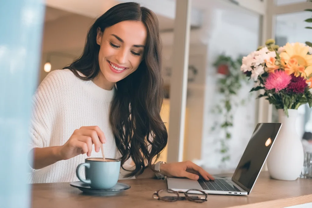 relaxed female employee enjoying coffee at work