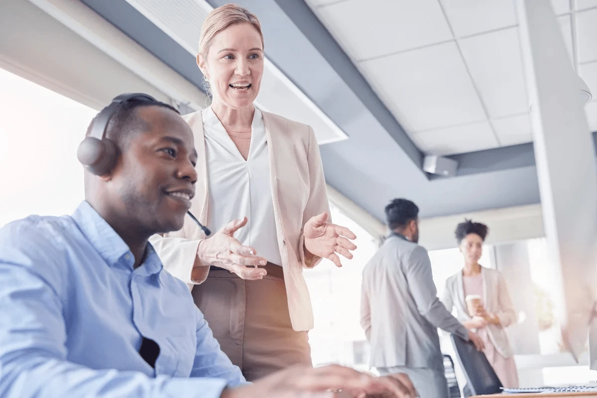 call center coaching taking place in a busy workplace