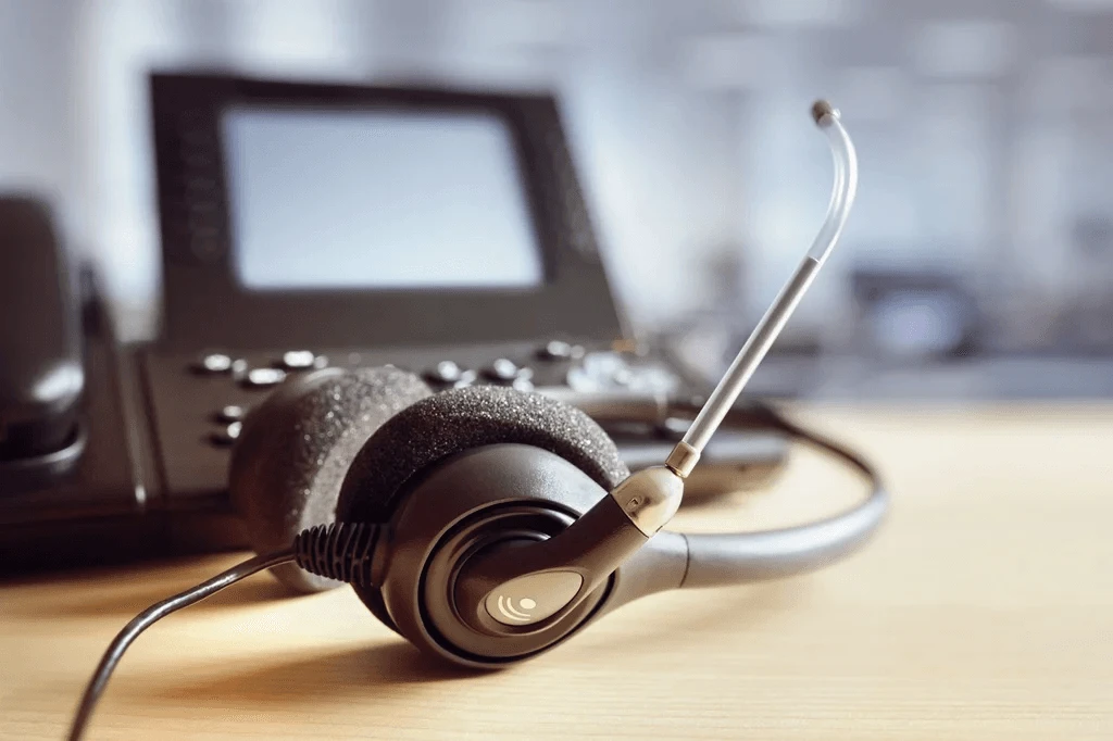 headphone and telephone in call center workplace