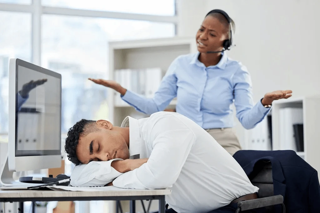 team leader disappointed with a colleague for sleeping at work