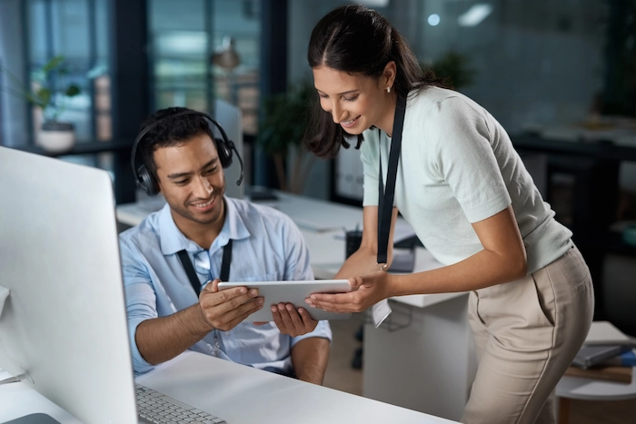 IT support woman helping a man using the system