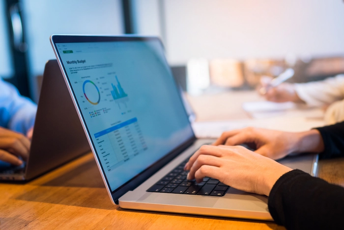 bookkeeping female office worker working on a laptop handling budget