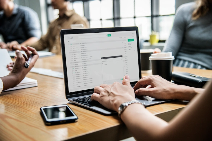 email marketing woman-checking her email in a meeting