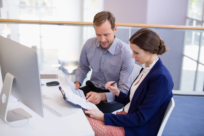 hr outsourcing two human resource employees checking potential candidates