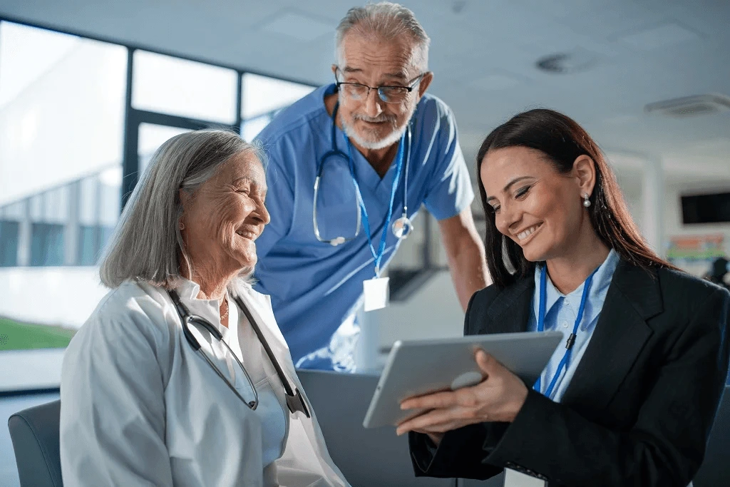 female digital marketer happily showing media contents to the doctors