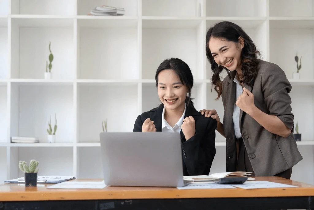 two female employees are satisfied with their paycheck