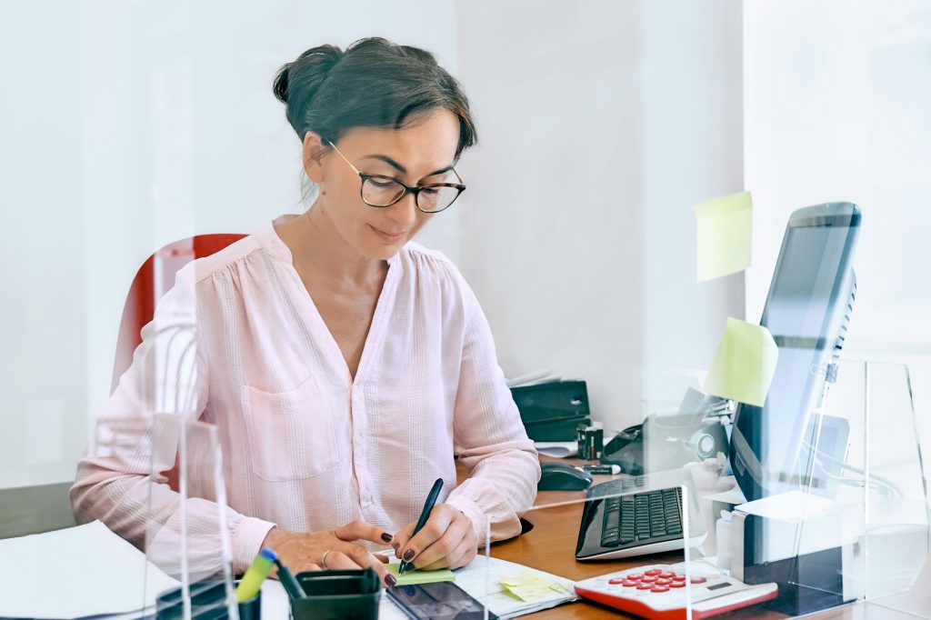 Attentive female bookkeeper check accounts bills.