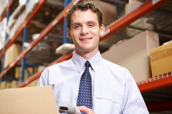 businessman scanning package in warehouse