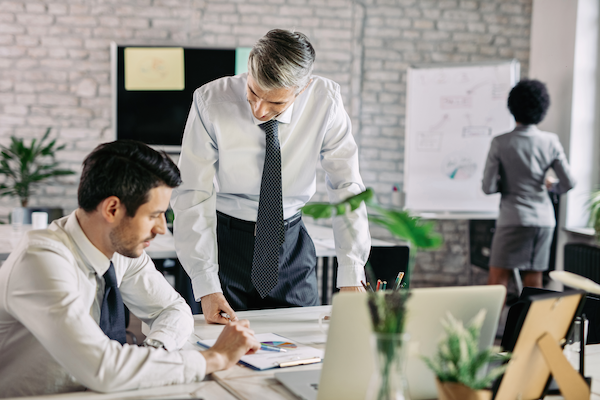 businessmen cooperating while analyzing business