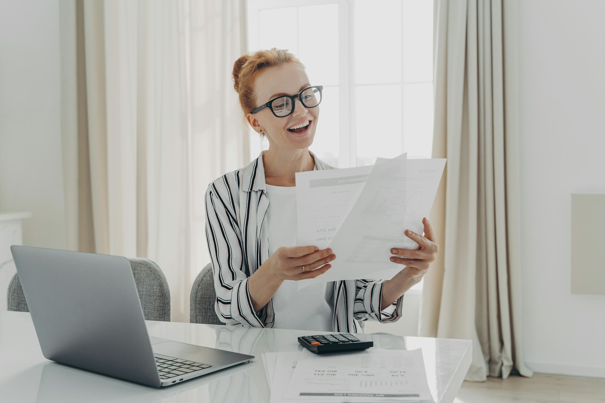 Cheerful professional accountant prepares annual financial report looks at documents