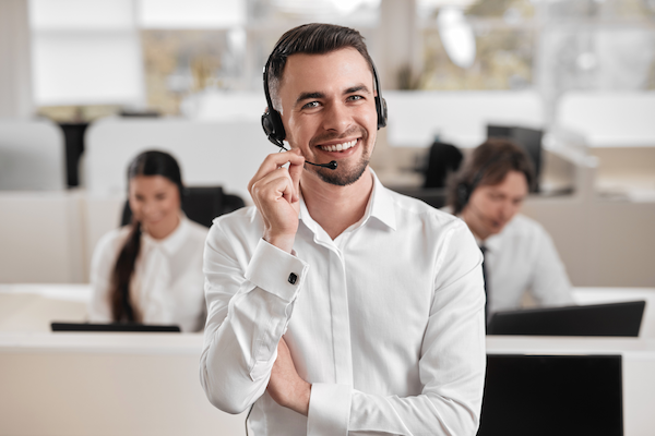 content male employee talking via mic of headset