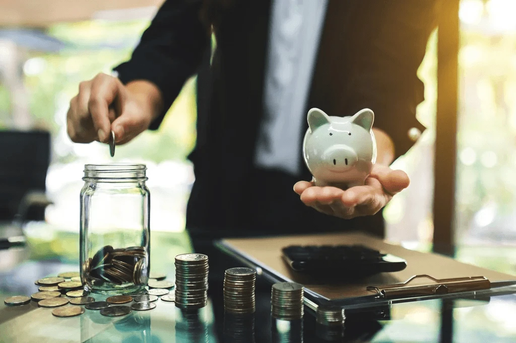 cost benefits of contact center outsourcing represented by a piggy bank and coins