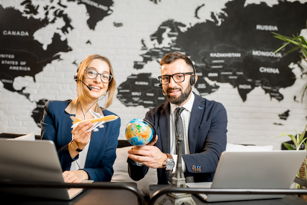 couple of travel managers working at the office