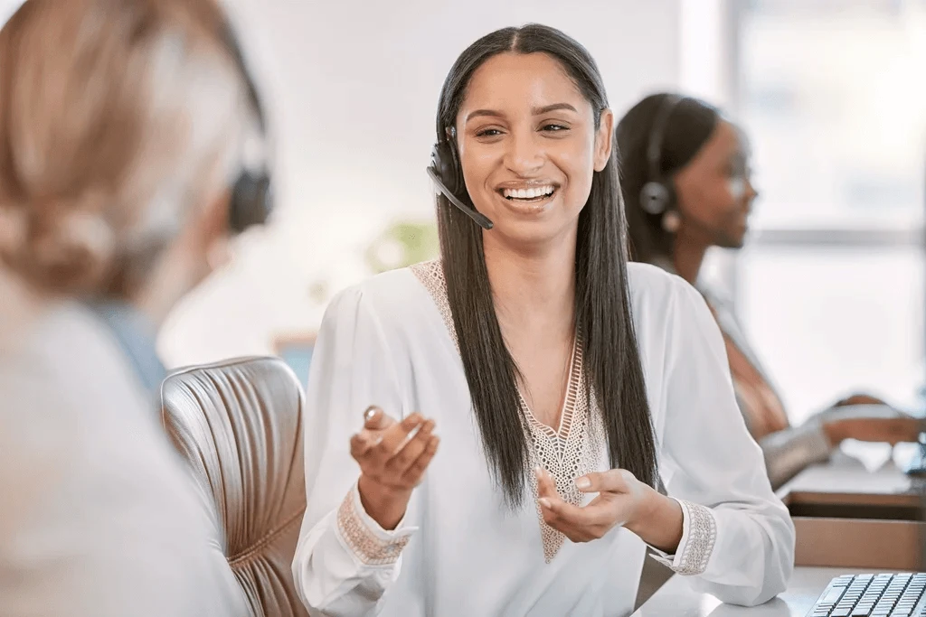 customer service agent discussing with her coworker