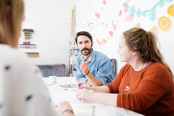 female and male designer having brainstorm meeting