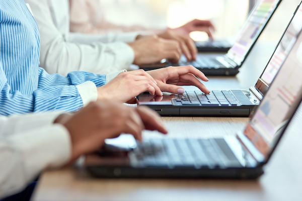 female hands typing on laptop