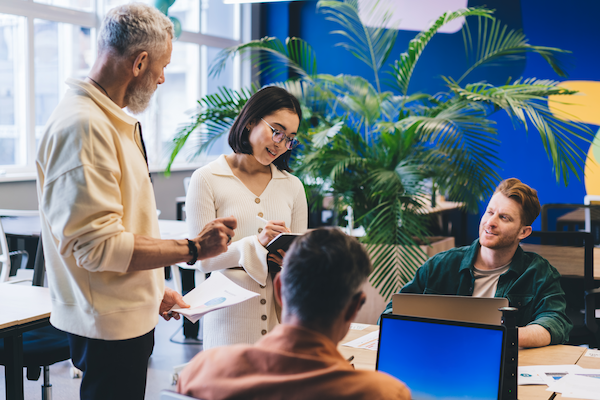 group of employees with technology discussing