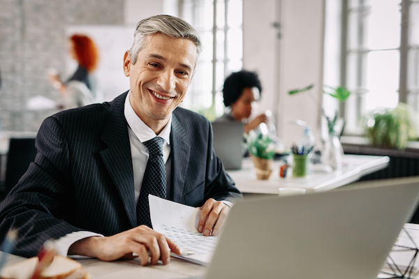 happy businessman analyzing business reports