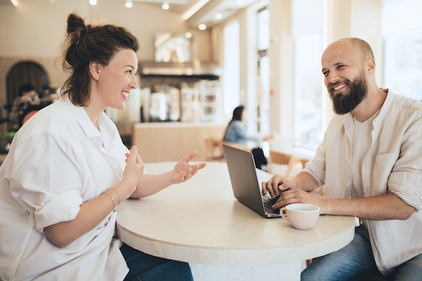 millennial man and woman discussing business