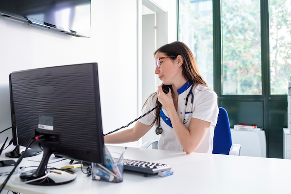 nurse talking on telephone in hospital