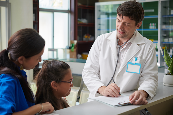 pediatrician filling medical card