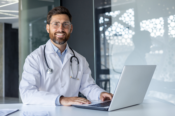 portrait of a young smiling male doctor sitting