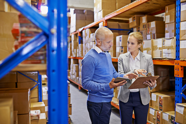 shot of a man and woman inspecting inventory