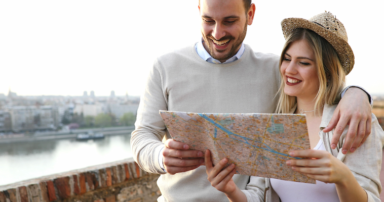 smiling couple in love traveling with a map