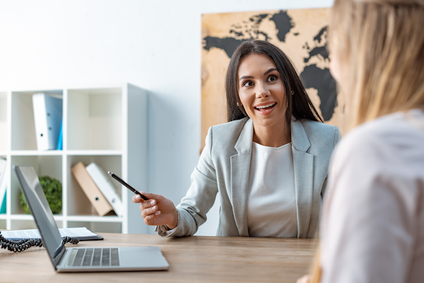 smiling travel agent talking to client