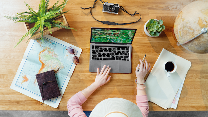 top view of young woman with laptop and map