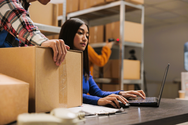 warehouse workers preparing parcel for delivery