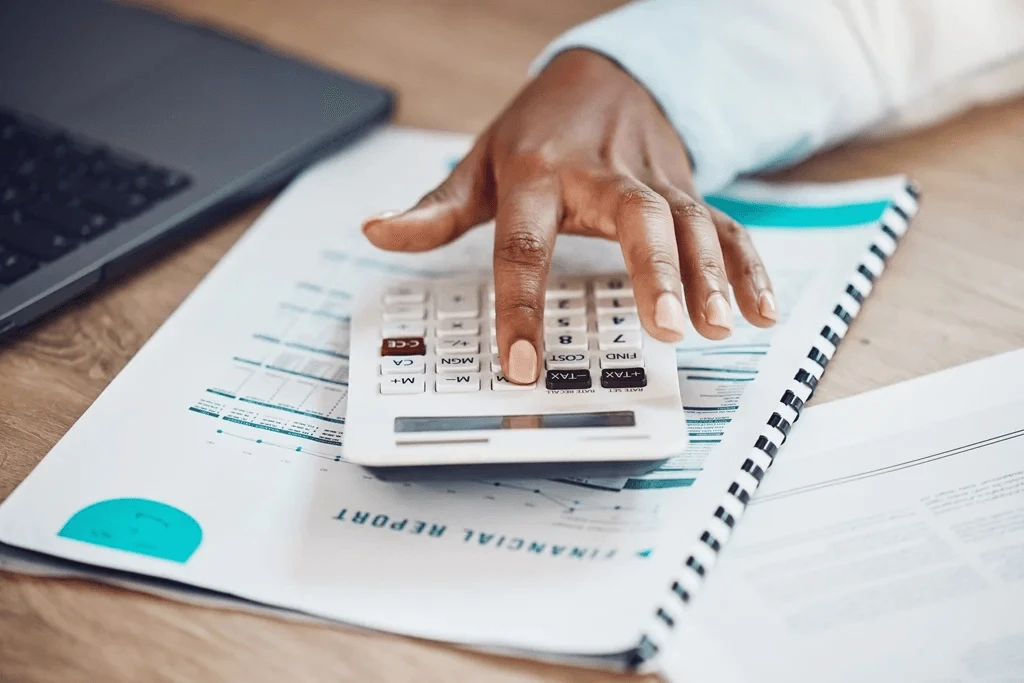 closeup of a professional bookkeeper using a calculator