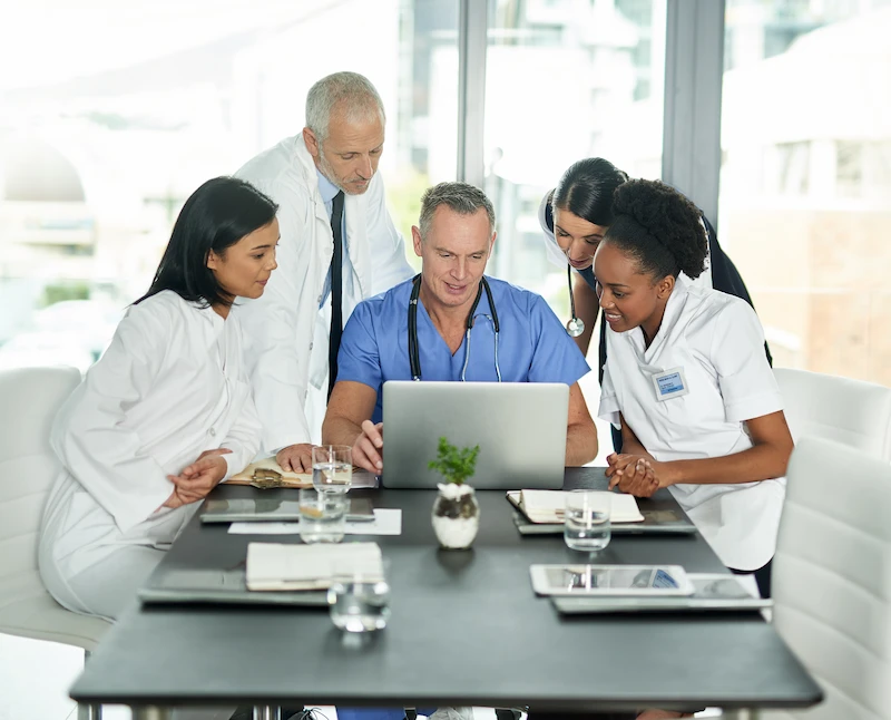 healthcare professionals checking something on the laptop