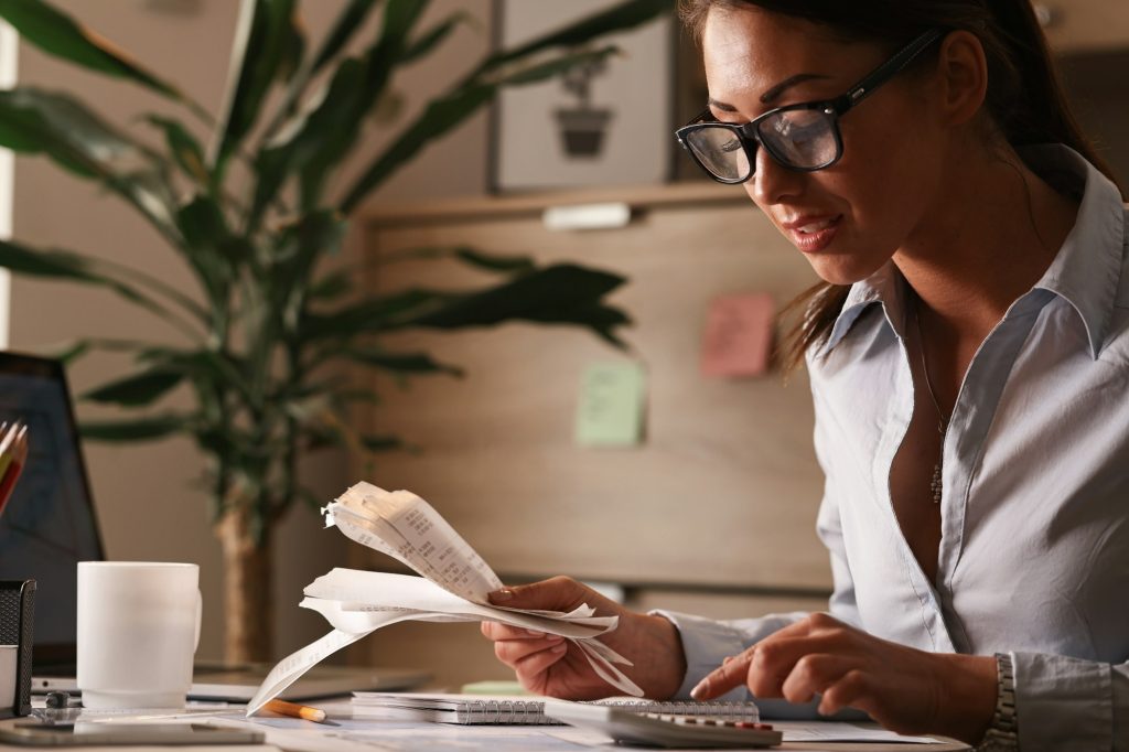 Young female accountant working in the office.